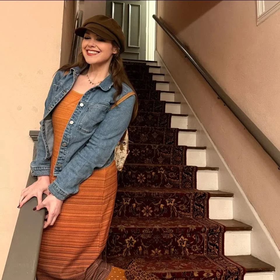 Kristin in a newsboy cap and denim jacket